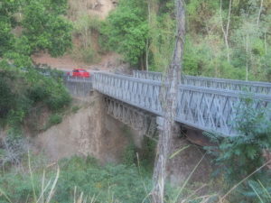 This car sped across a one-lane bridge at practically double the posted speed because at least the road is level across the bridge