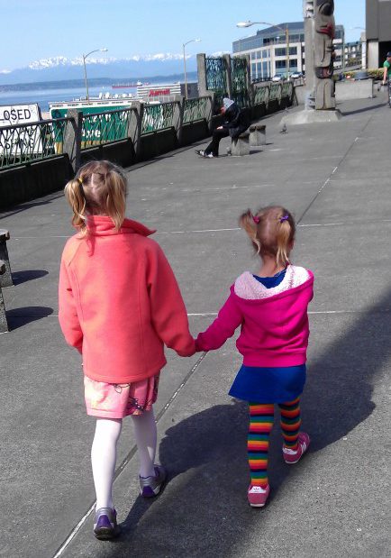 little girls walking holding hands